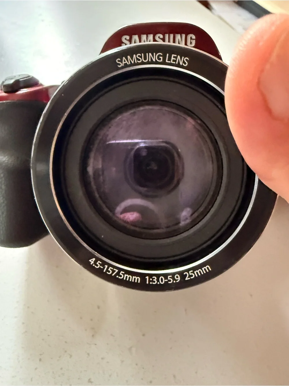 Samsung glossy red digital bridge camera with Samsung lens